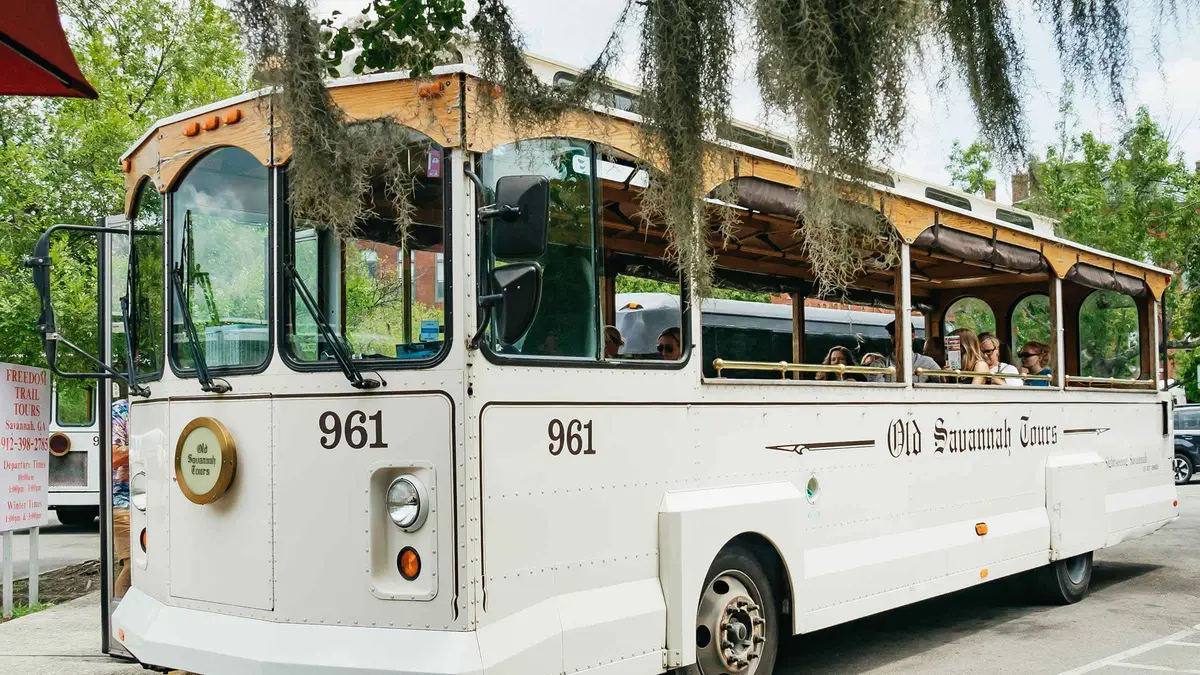 Open-air trolley on a cobblestone street in Savannah on a day trip from Charleston, South Carolina