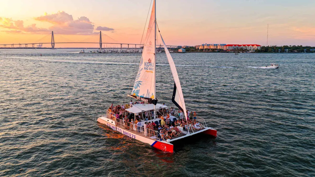 Catamaran at golden hour on a sunset Charleston harbor cruise from Shem Creek, a cruise from Charleston
