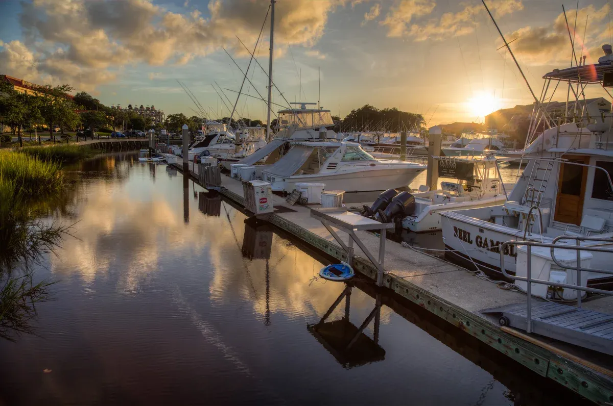 Motor yachts moored at a marina on the Ashley River in Charleston at sunset, the base for a private yacht charter in Charleston