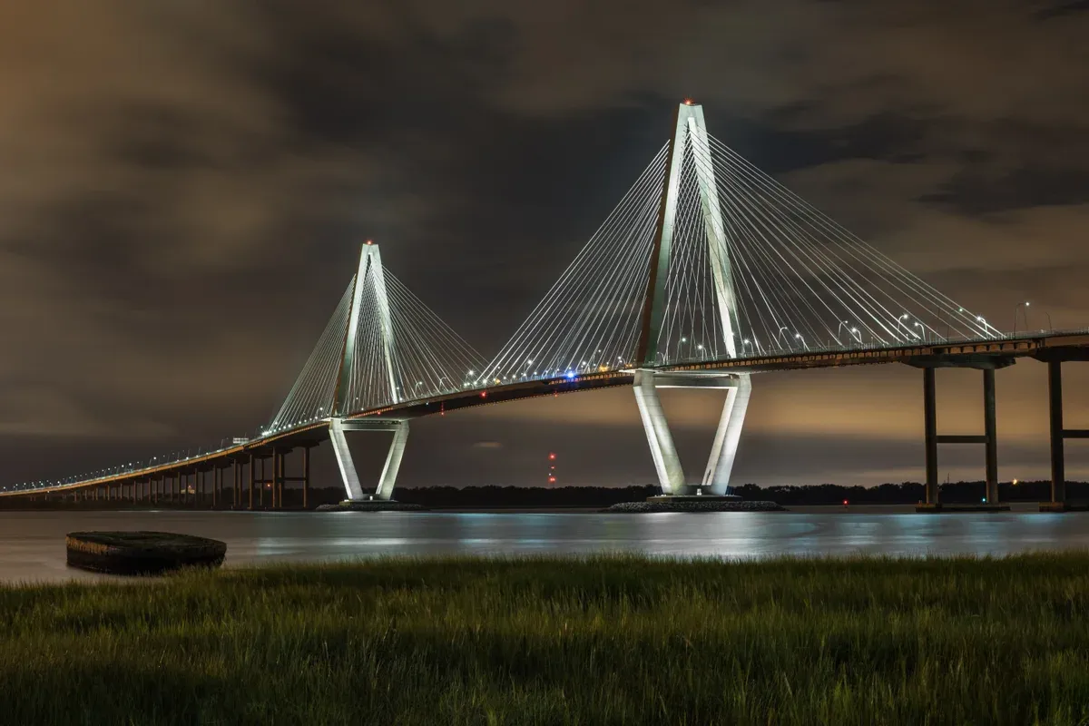 Arthur Ravenel Jr. Bridge lit at night over Charleston Harbor, view from a Charleston harbor dinner cruise