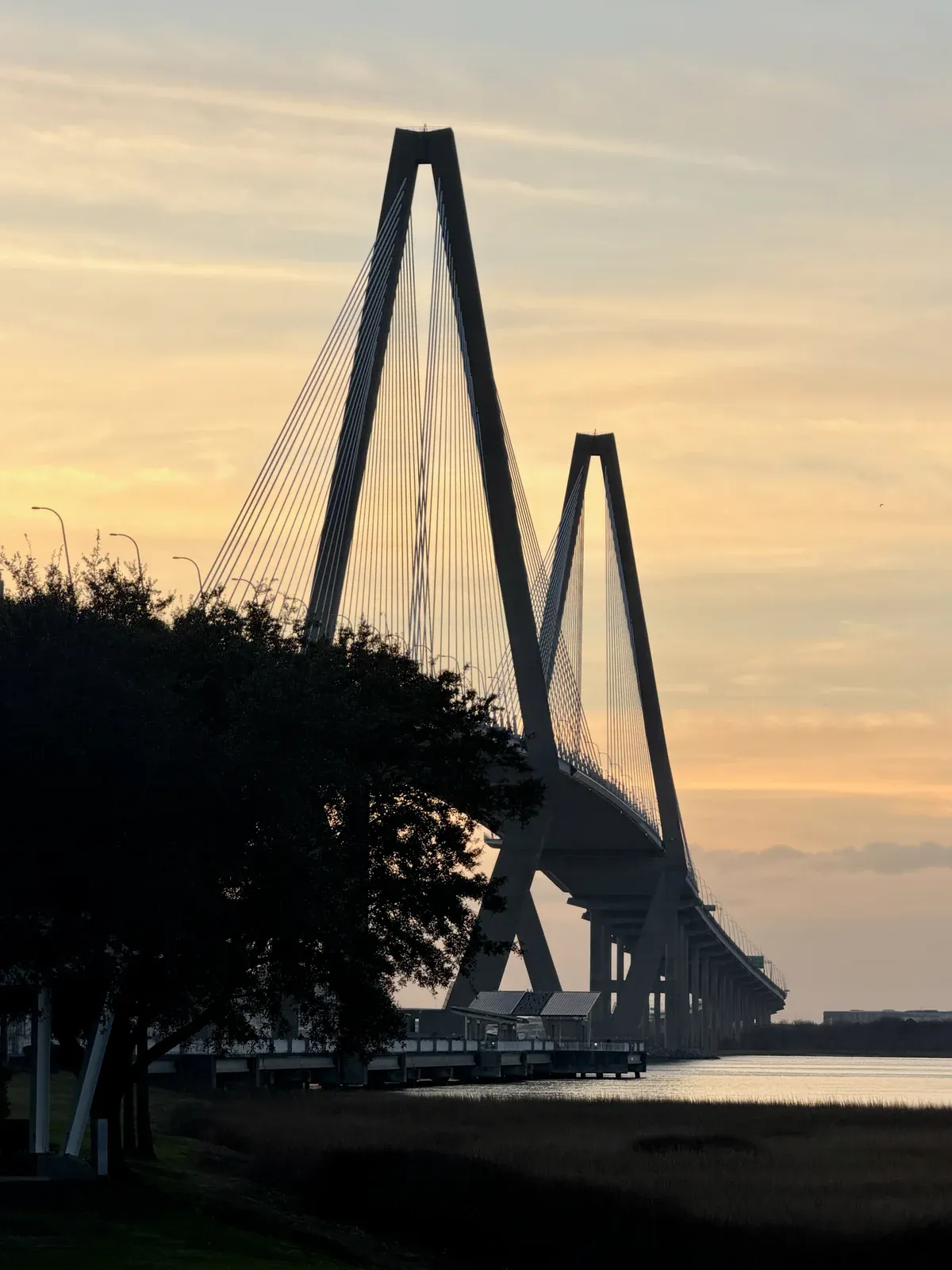 Arthur Ravenel Jr. Bridge against a sunset sky, a landmark of a Charleston harbor sunset cruise