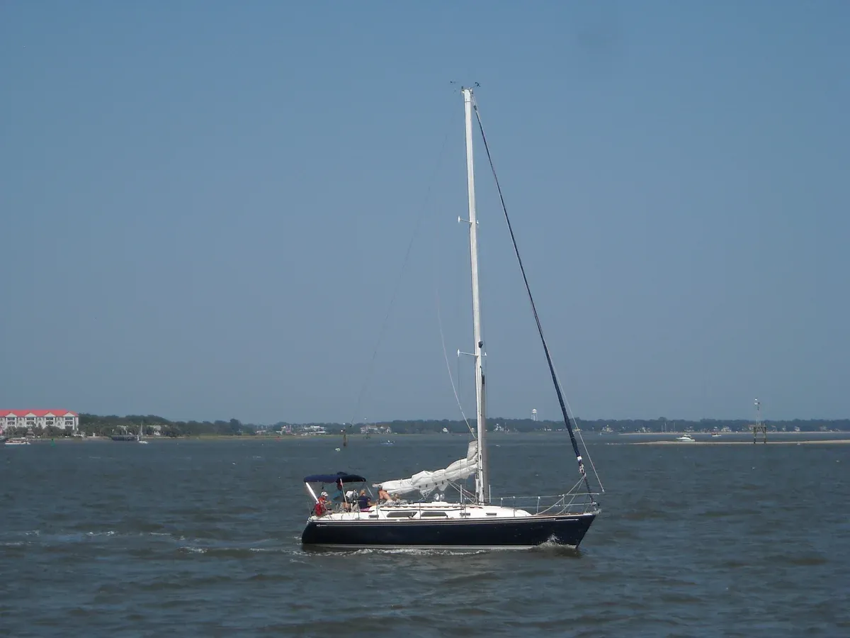 Cruising sailboat on the water off Charleston, the kind of boat a sailing charter in Charleston uses